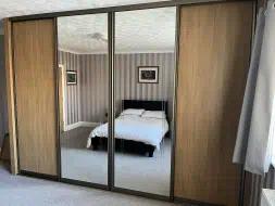 Lancaster oak and mirror sliding doors in light bronze frames (alternative angle), fitted in Ingleby Barwick
